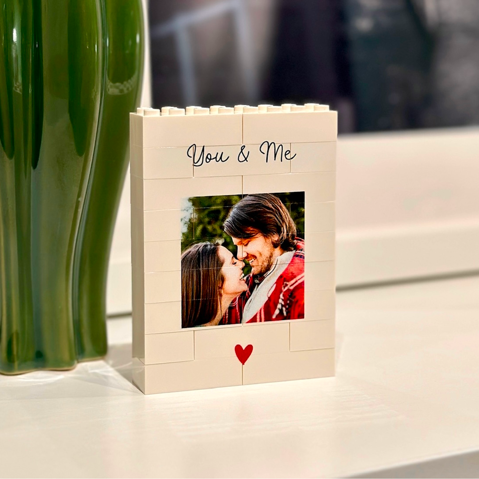 Personalized photo block made of interlocking LEGO bricks with a festive couple's photo and 'You & Me' text.